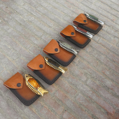 Fish folding pocket knife closed position showing compact carry design and artistic handle shape.