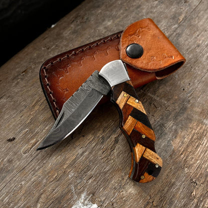 Closed fish design pocket knife showing honeycomb patterned handle and engraved decorative details.