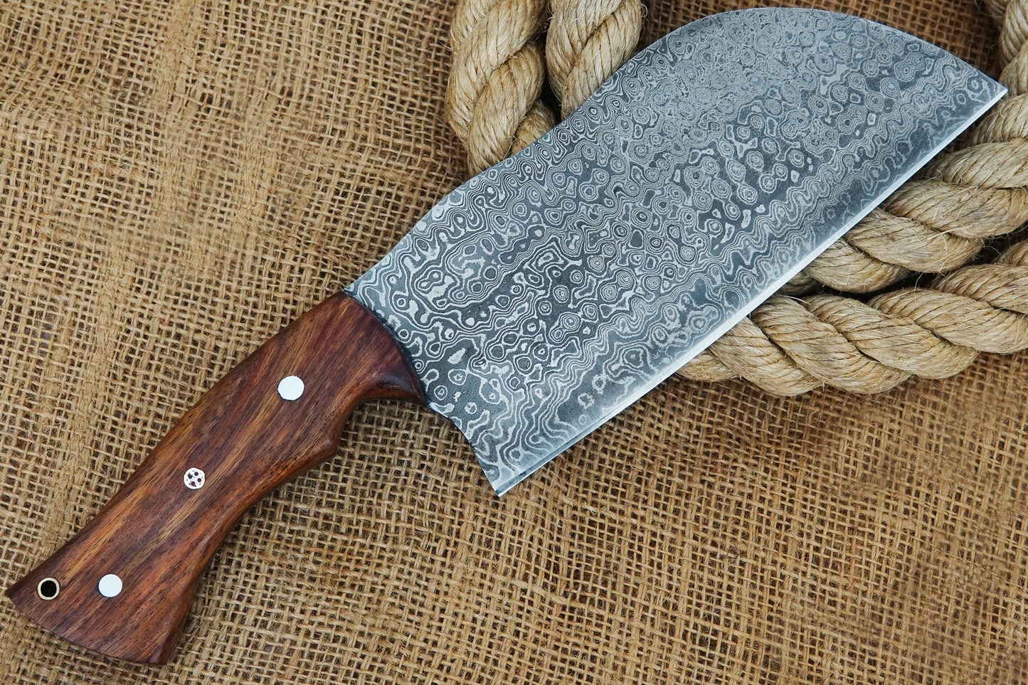 This Serbian cleaver knife is crafted from Damascus steel with a durable full tang blade and elegant rose wood handle. Designed for chefs, BBQ lovers, and outdoor cooking. Free personalisation included to make it special.