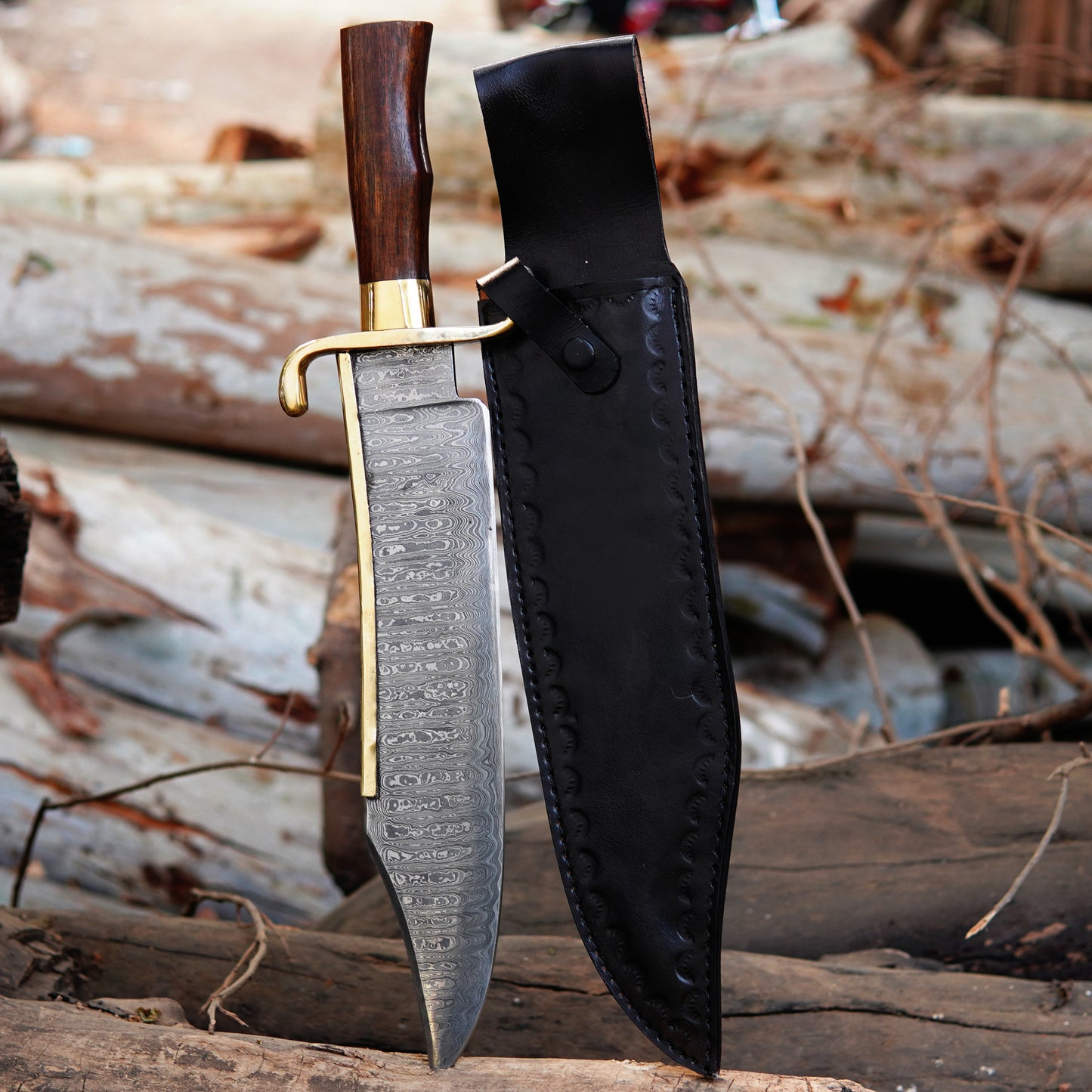 Handmade Damascus steel bowie knife placed on natural wood surface showing detailed layered blade pattern with polished wooden handle and brass guard. The image highlights craftsmanship, blade texture, and traditional outdoor knife design suitable for collectors, camping enthusiasts, and handmade knife buyers searching for premium quality fixed blade knives.