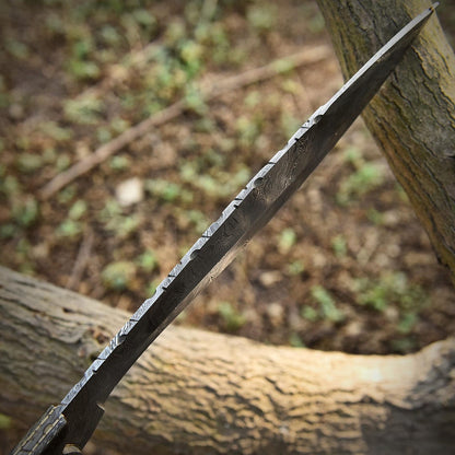 Close-up view of the Damascus steel Kukri blade, showing detailed forge patterns and unique layered texture. Built full tang for maximum durability, with a camel bone handle for a natural, comfortable grip ideal for outdoor, bushcraft, or display use.