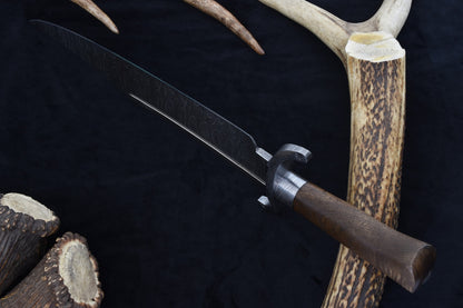 Custom Damascus Texas Bowie knife with walnut handle and layered steel blade patterns, perfect as a collector’s centerpiece or a rugged outdoor companion. Includes a hand-fitted scabbard for protection.