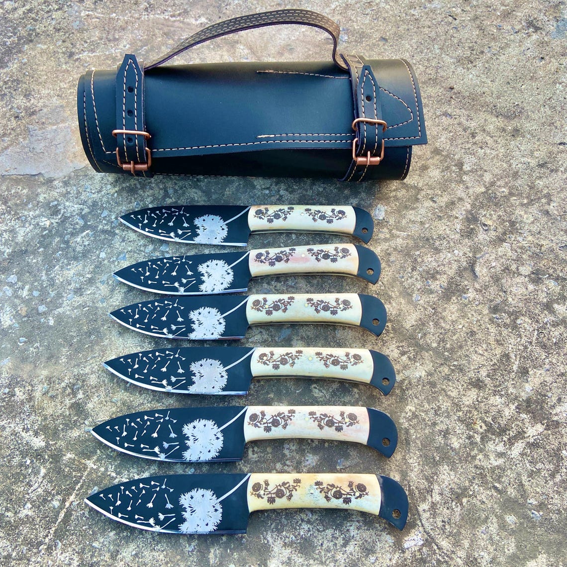 Set of six handmade carbon steel steak knives with dandelion blade engraving and floral handle design.