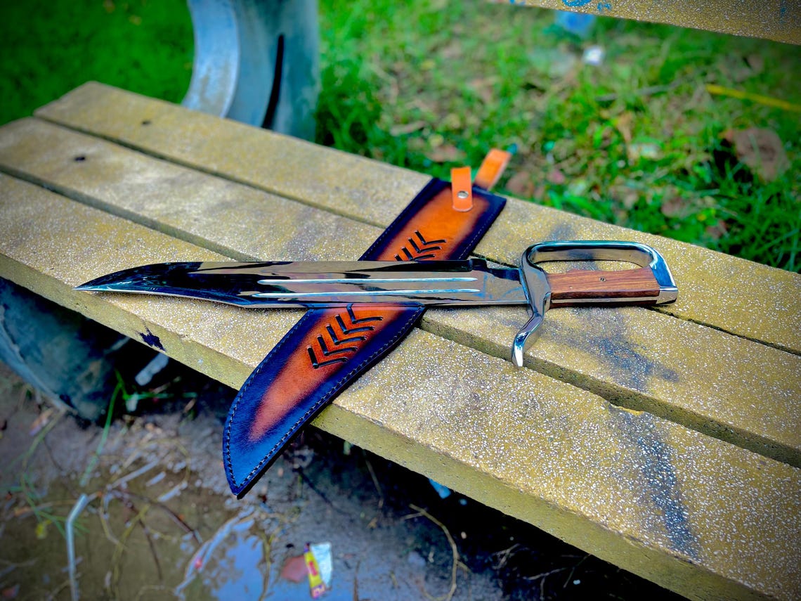 Close-up of polished D-Guard handle with rosewood grip and steel finish.