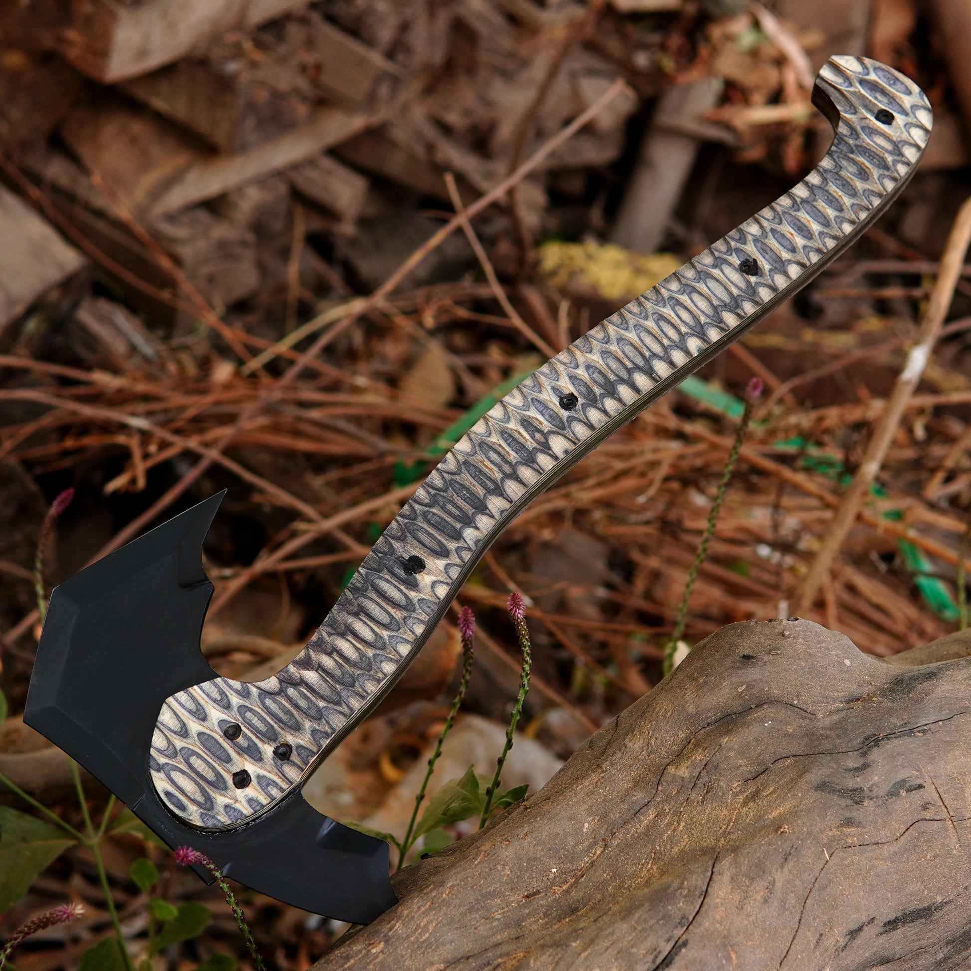 Full tang axe shown in a rustic outdoor setting highlighting balance and craftsmanship.