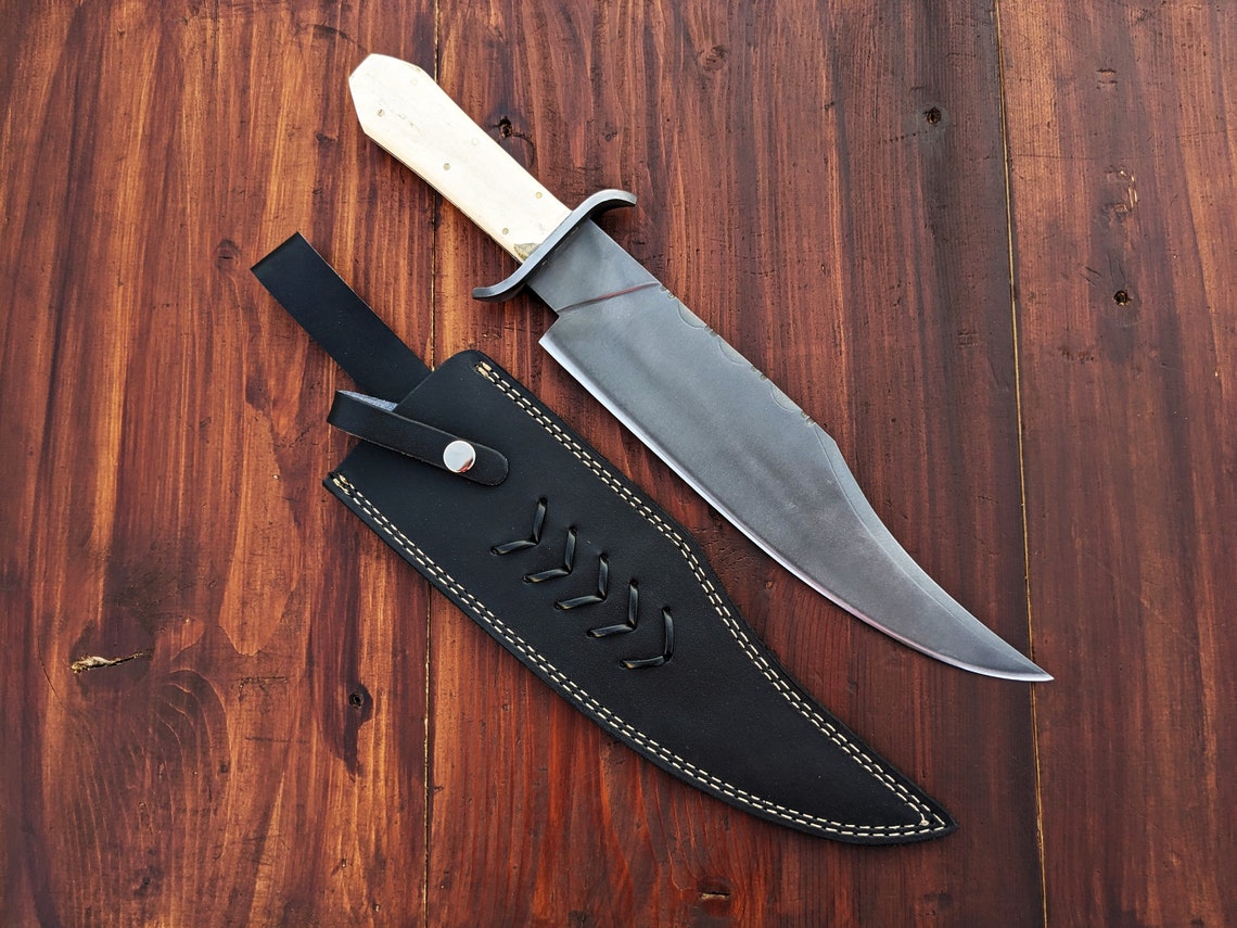 Handmade Bowie knife featuring carbon steel blade and elegant camel bone handle, ideal for hunting, camping, and survival enthusiasts seeking reliability and beauty.