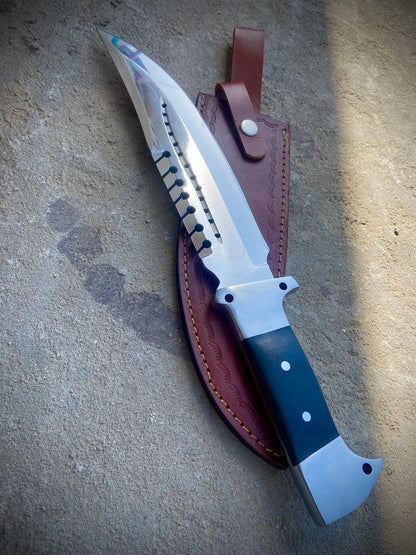 Close-up of high polish carbon steel hunting bowie knife blade with precision spine detailing.