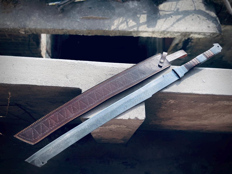Handmade Damascus steel Viking sword with full tang machete-style blade and brown leather sheath.