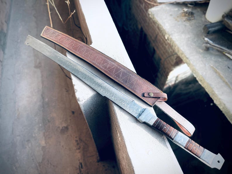 Full tang Damascus steel machete-style Viking sword shown outdoors.