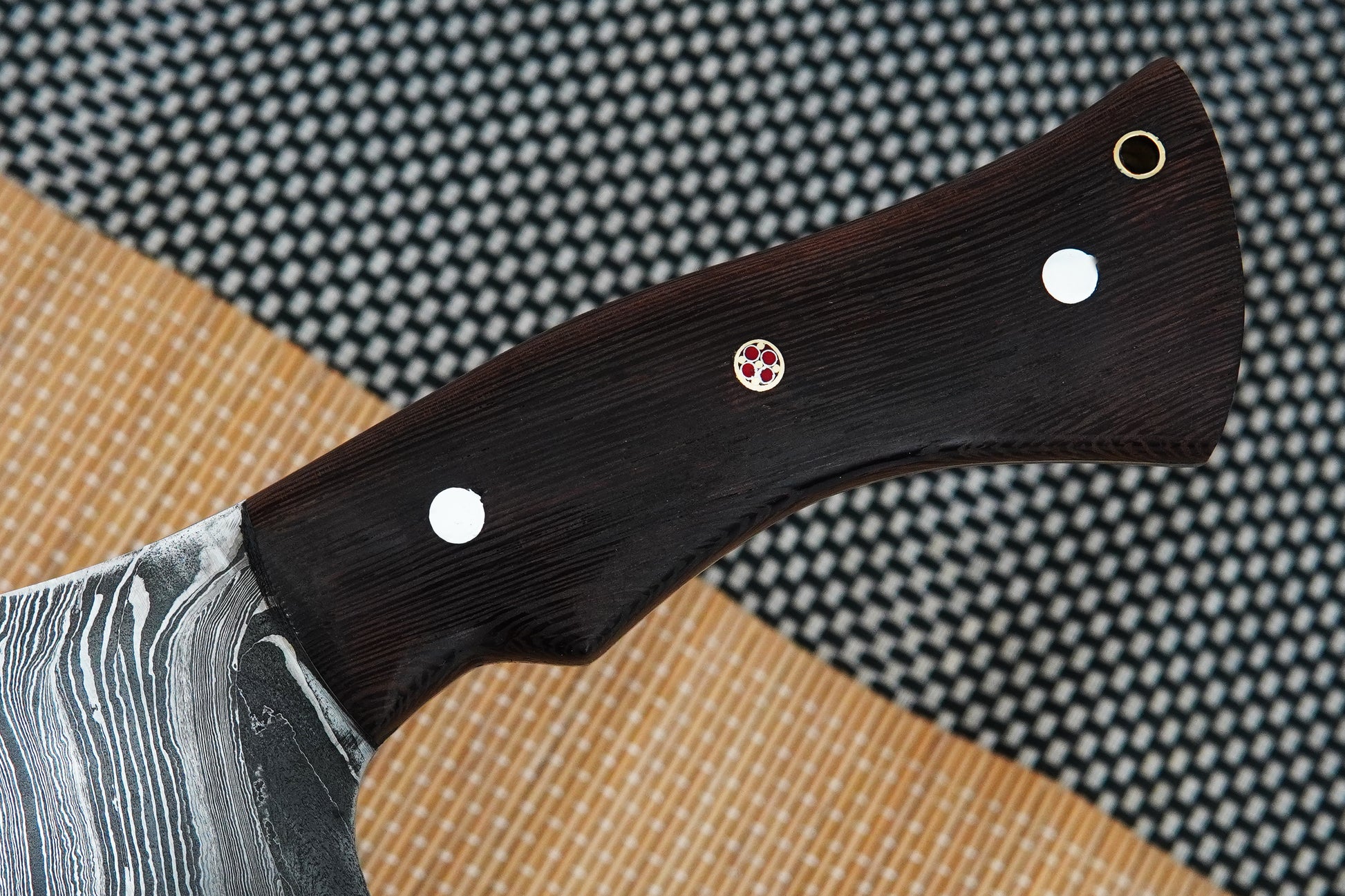 This full tang meat chopper is forged from Damascus steel and finished with a strong wenge wood handle. Handmade for strength and comfort, it works perfectly for heavy chopping tasks in the kitchen or outdoors. Free engraving option included.