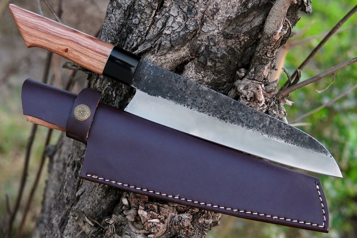 A hand forged chef knife crafted from 5160 spring steel with a natural olive wood handle. This full tang knife is perfect for camping, outdoor BBQ, or daily kitchen use. Durable, stylish, and available with free custom engraving.