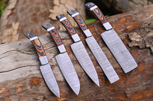 5 piece Damascus steel full tang kitchen knife set displayed with leather roll