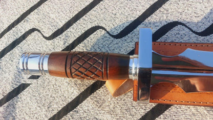 Wooden handle dagger knife showing carved grip and balanced design.