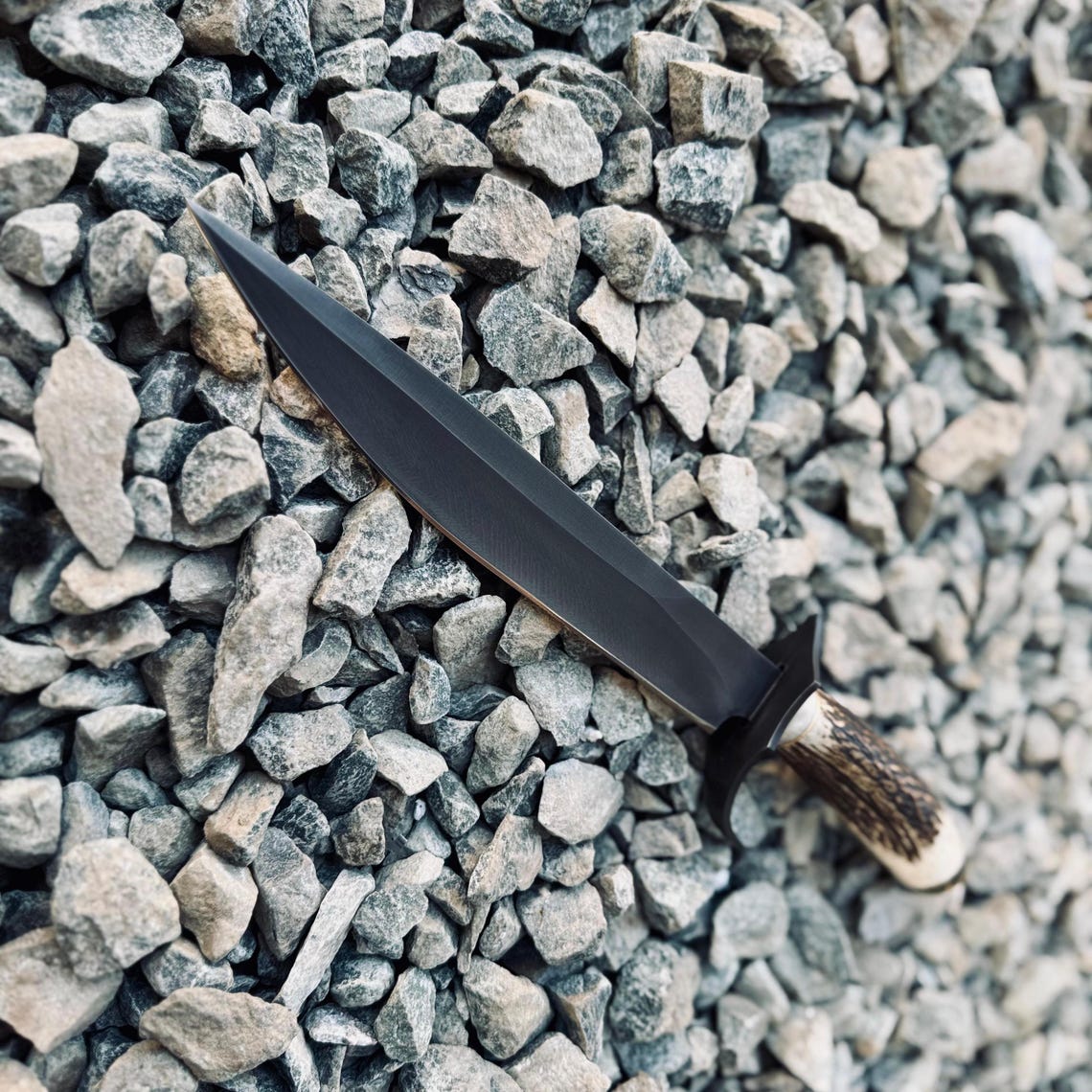 Outdoor Bowie knife with natural stag handle and 5160 spring steel blade, ideal for survival, bushcraft, and camping. Includes handmade stitched leather sheath.