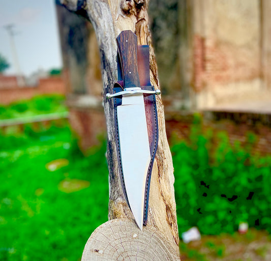 Handmade Bowie knife crafted from 1095 carbon steel with a polished blade, featuring an elegant wenge wood handle and a premium hand-stitched leather sheath.