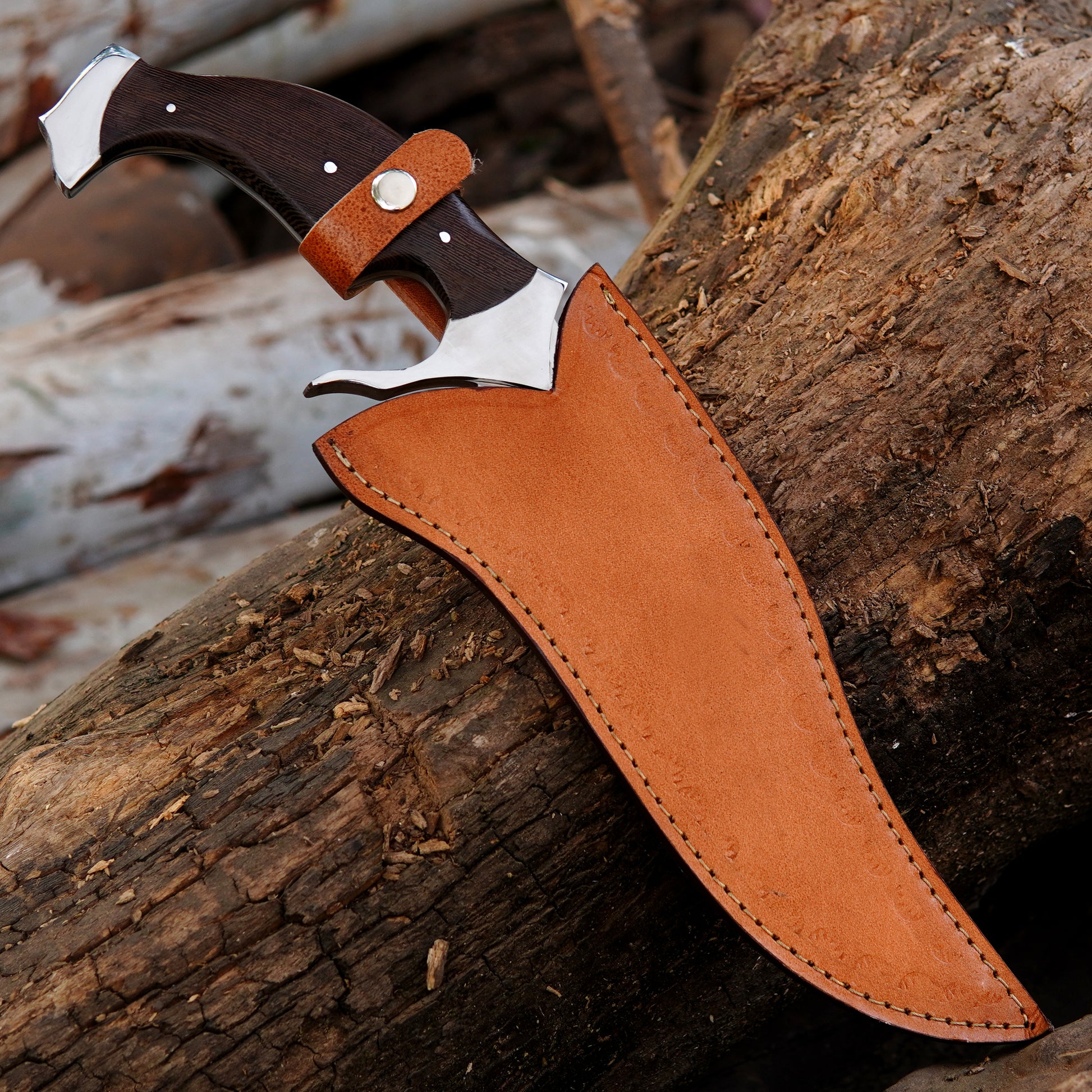 Close view of handmade bowie knife handle showing smooth finishing, ergonomic shape, and detailed craftsmanship. The natural texture of the handle enhances grip comfort while maintaining a premium appearance, making it suitable for collectors and outdoor enthusiasts looking for durable handmade tools.