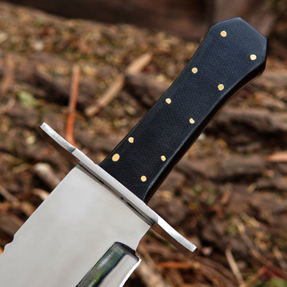 Bowie style knife shown in a rustic setting highlighting balance and handcrafted quality.