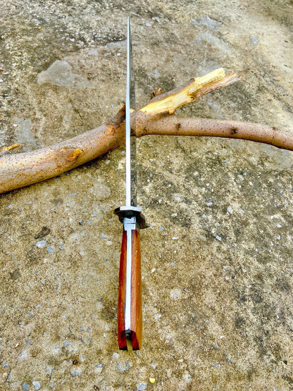 Elegant handmade carbon steel Bowie knife displayed with its leather sheath, showcasing the polished blade and beautiful rosewood coffin handle. The knife’s ergonomic grip and full tang design ensure control, strength, and precision for outdoor use or display.