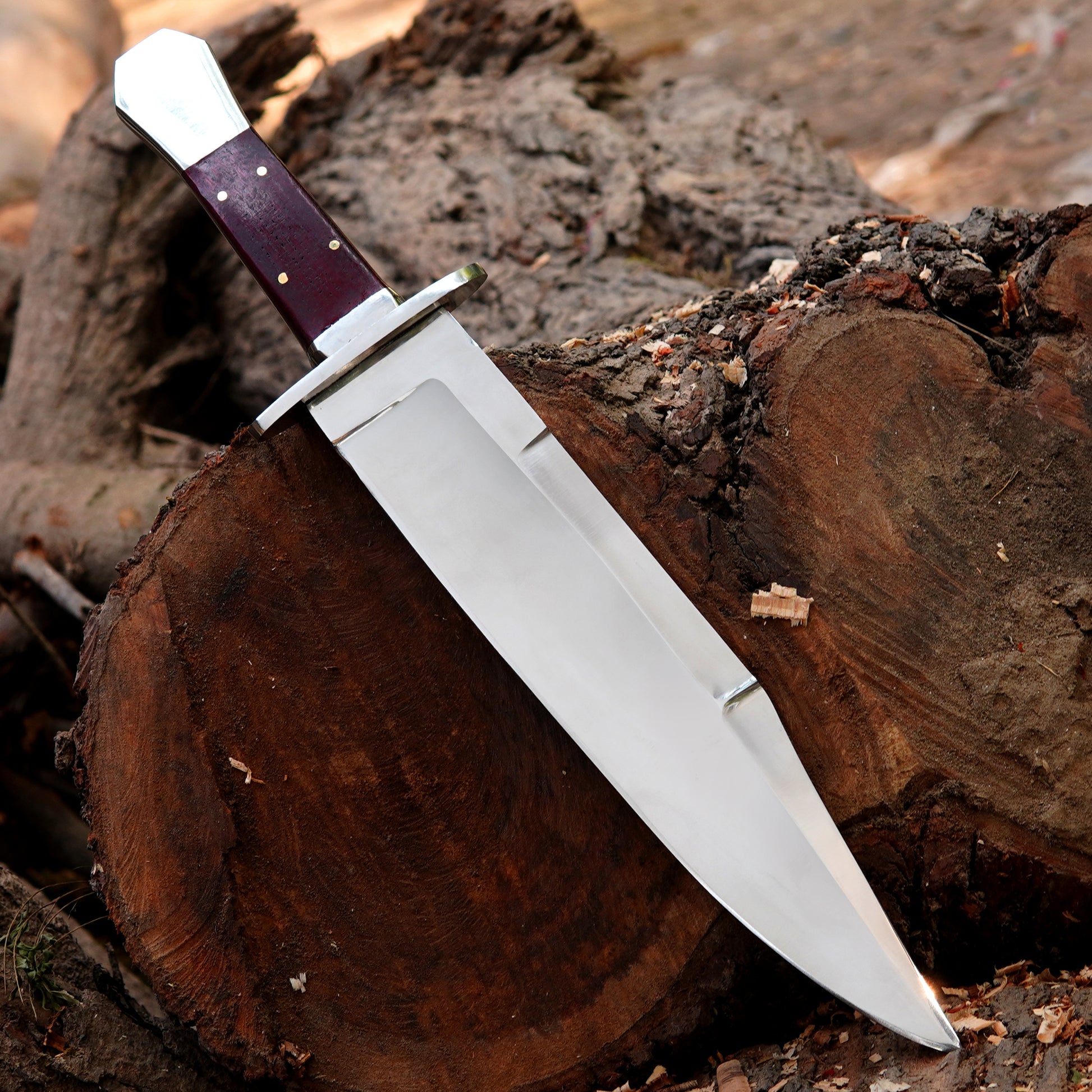 Custom crafted bowie knife featuring a smooth polished blade and ergonomic wooden handle.
