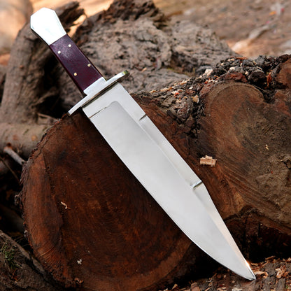 Custom crafted bowie knife featuring a smooth polished blade and ergonomic wooden handle.