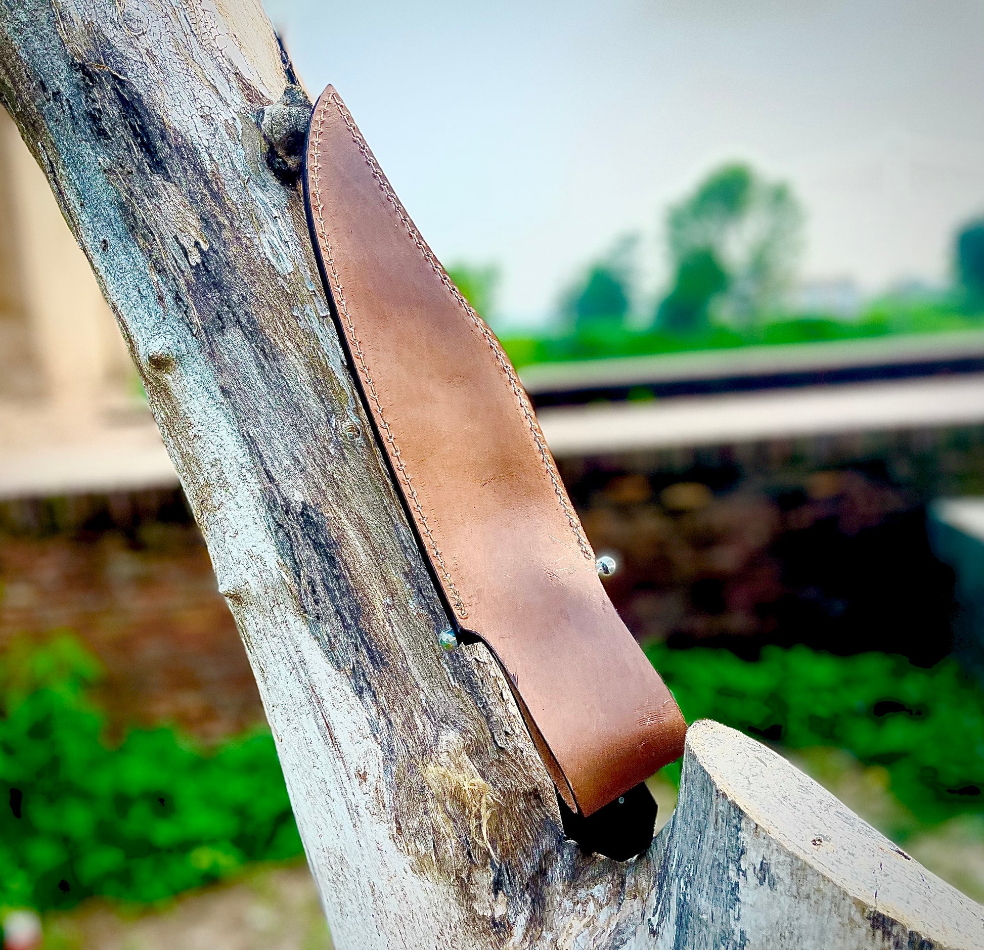 Classic Bowie knife handcrafted from 1095 carbon steel with a smooth finish, featuring a rich wenge wood handle and custom stitched leather sheath.