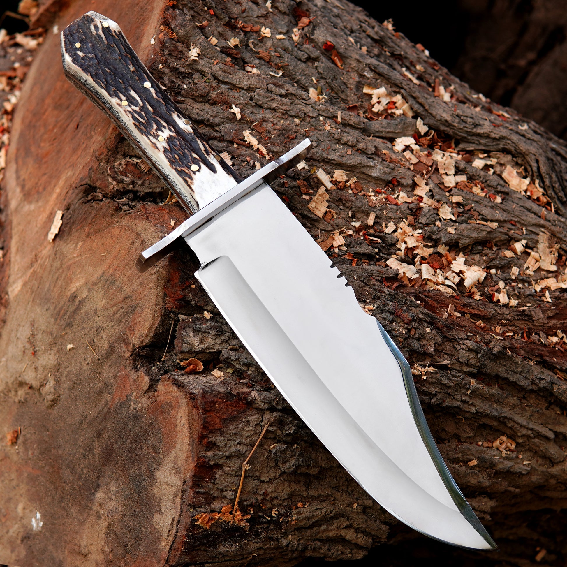 Custom crafted bowie knife showing clean blade finish and textured natural material handle.Custom crafted bowie knife showing clean blade finish and textured natural material handle.