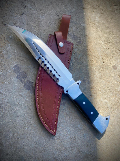 Handmade full tang hunting bowie knife with mirror-polished carbon steel blade and leather sheath.