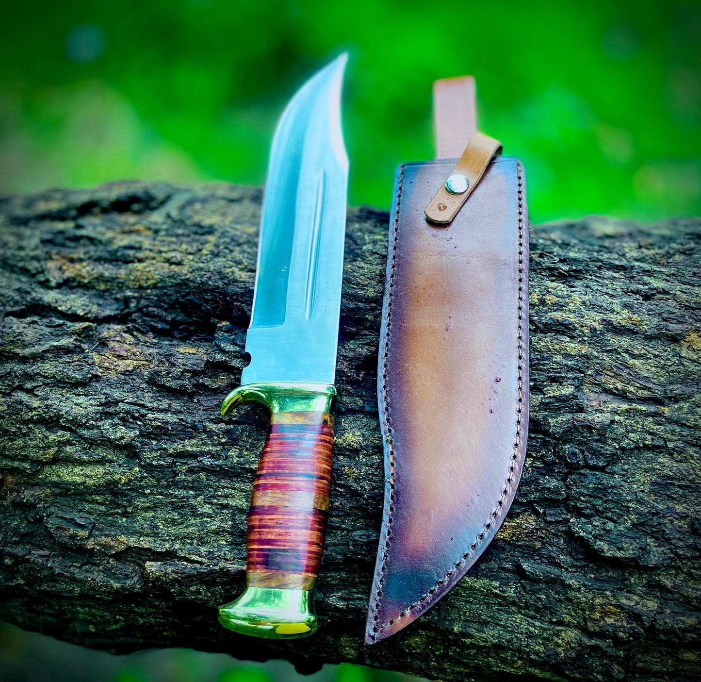 Handmade Crocodile Dundee Bowie knife with razor-sharp carbon steel blade and stacked leather handle, paired with a handcrafted leather sheath. The knife is designed for durability and balance, ideal for outdoor adventures, camping, hunting, and collectors who value traditional Bowie knife craftsmanship with a legendary design.