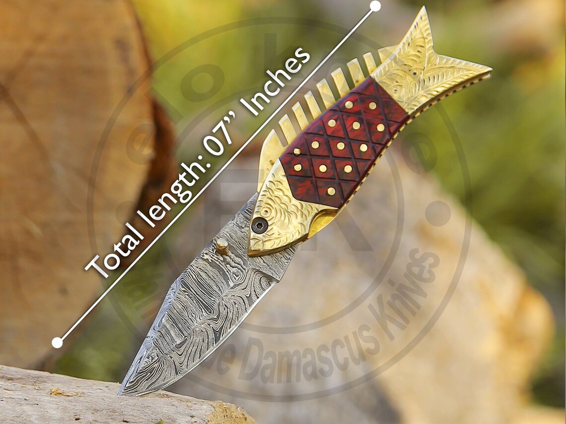 Unique fish design Damascus folding knife with twist pattern and engraved brass spine.