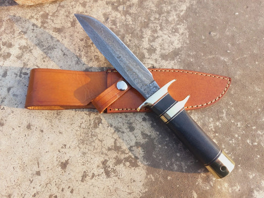 Handmade Damascus hunting knife with subhilt design, micarta handle for durability, and brass guard for balance. Comes with a hand-stitched leather sheath for safe storage and carrying. Perfect for outdoor hunting, camping, and collectors who value craftsmanship and functional artistry.