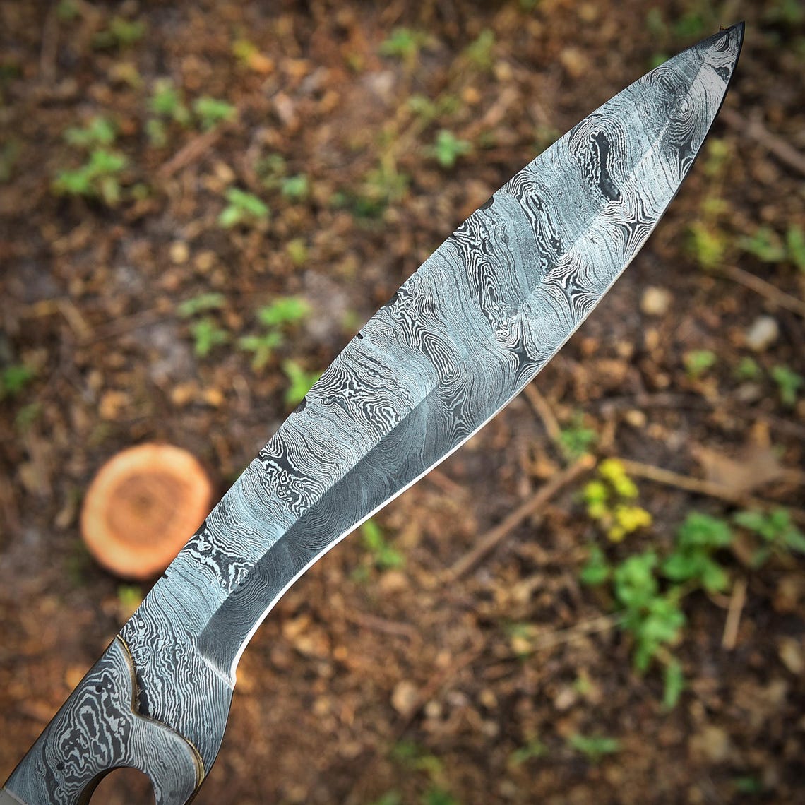 Damascus steel Kukri Bowie knife in action, hand-forged and full tang, built for strength and heavy outdoor work. Features a sharp cutting edge and camel bone handle, making it a perfect choice for hunting, chopping, and survival enthusiasts.