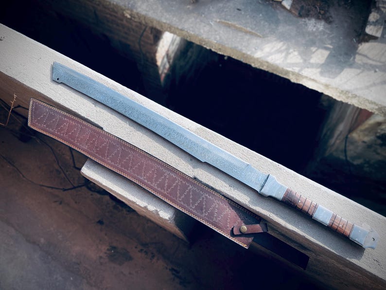 Close-up of wooden handle and steel tang of handmade Viking sword.