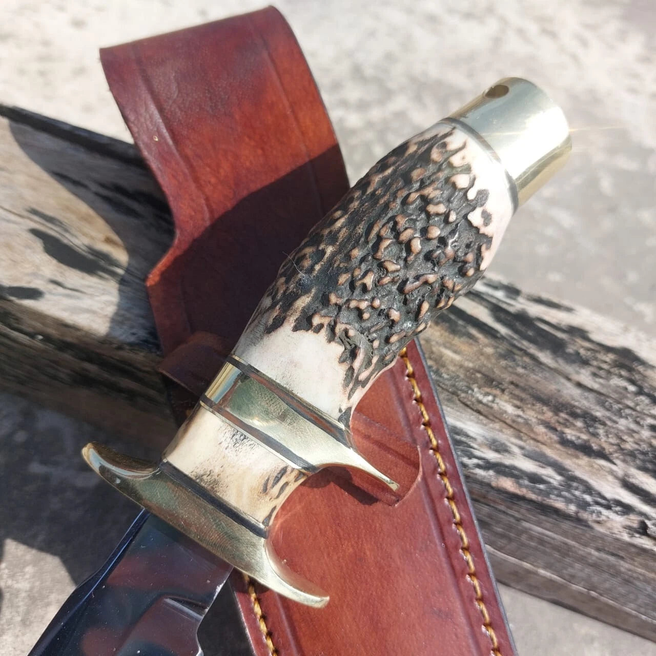 Fixed blade hunting knife made with high carbon steel for edge retention and toughness. Designed with a subhilt guard and brass fittings for balance. The included leather sheath provides protection and portability, making it perfect for outdoor use and as a collector’s knife.