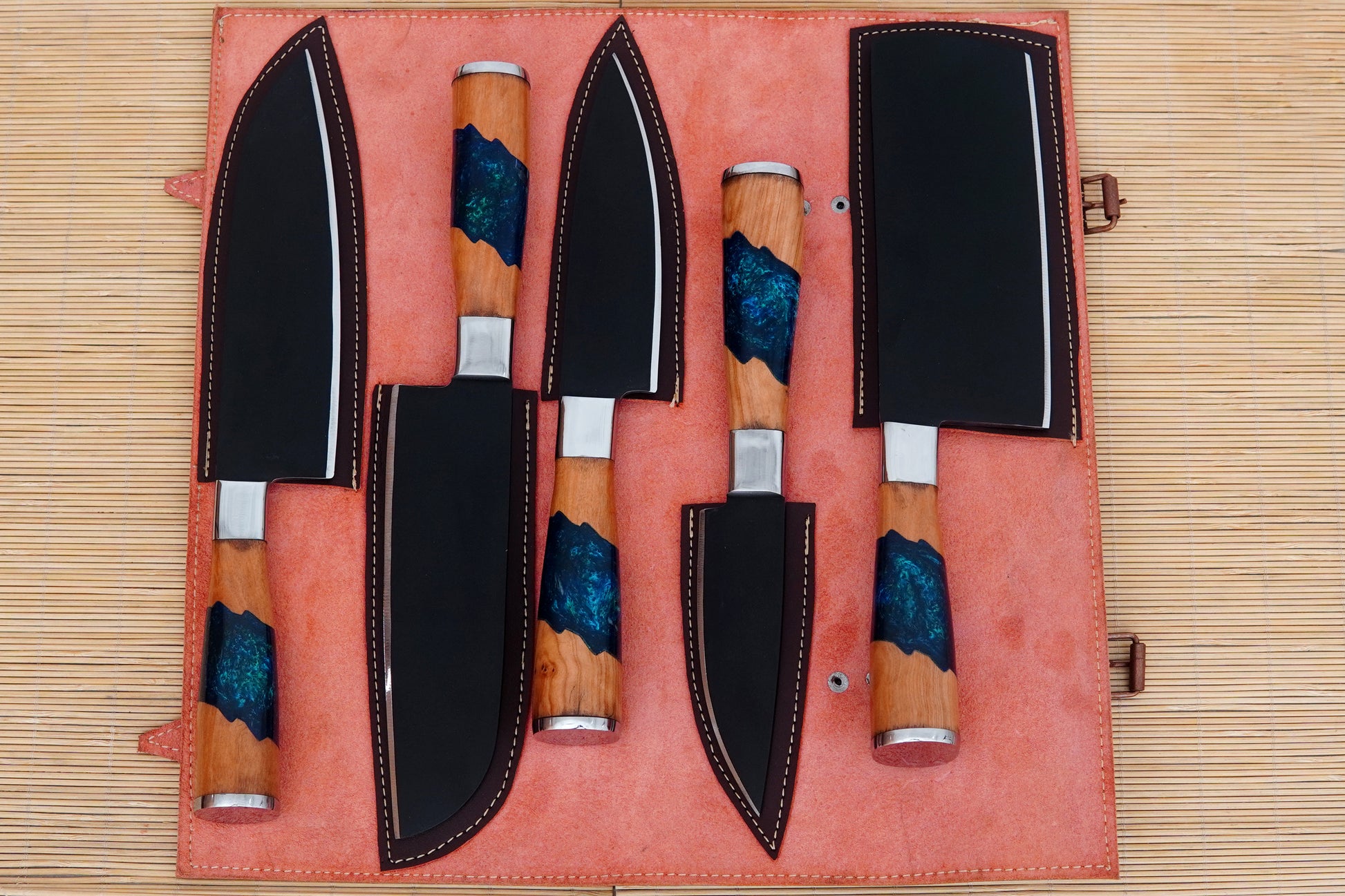 A handmade kitchen knife set featuring 5 black carbon steel blades with resin handles. Each knife is sharp and functional, designed for professional or home chefs. The set comes with a leather sheath and free engraving for a personal touch.