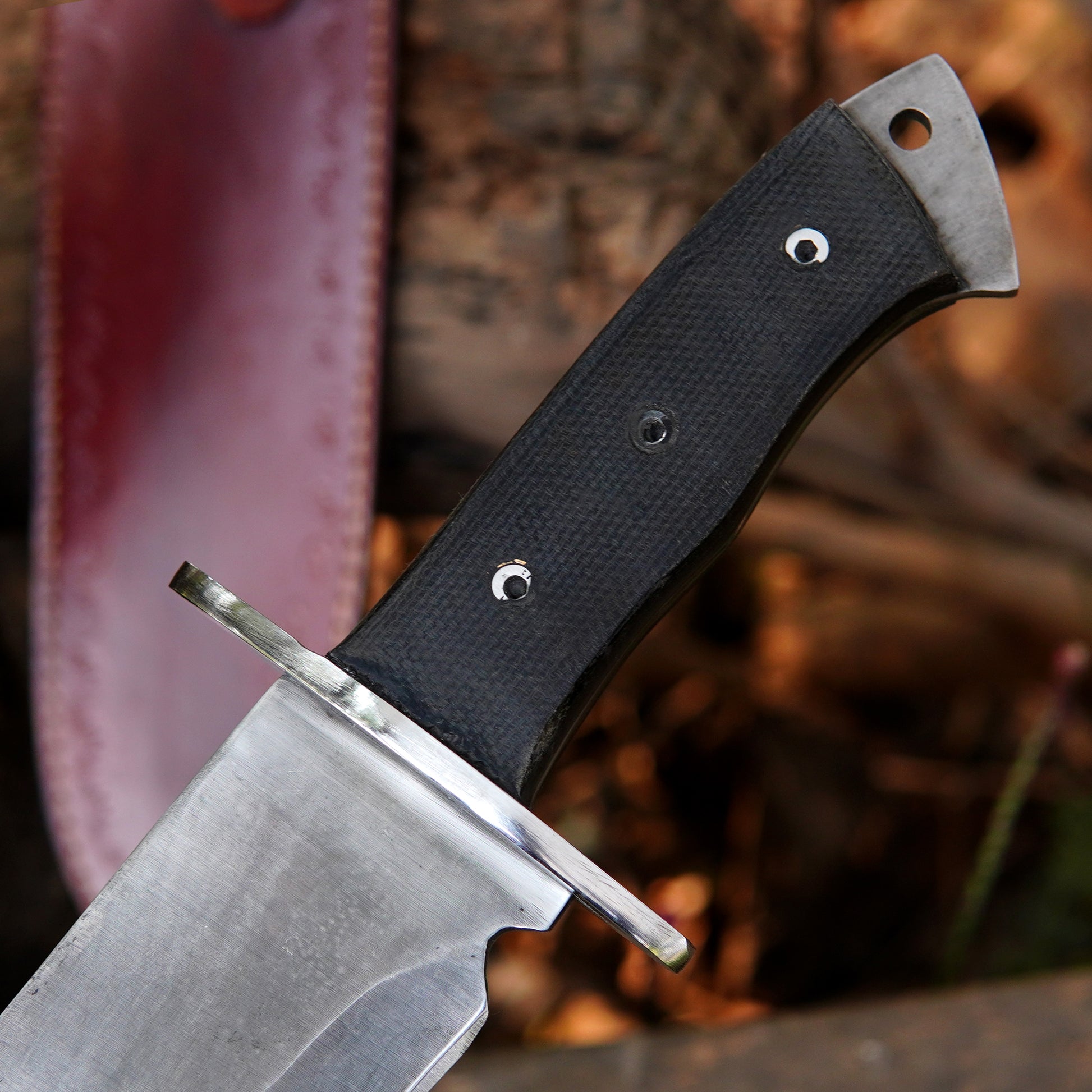 Bowie style knife shown in a rustic setting highlighting balance and handcrafted quality.