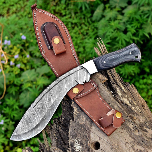 Handmade Damascus steel Kukri knife featuring a full tang forged blade, black Micarta handle, and decorative file work along the spine. Includes a hand-stitched brown leather sheath, perfect for collectors, hunters, and outdoor survival use.