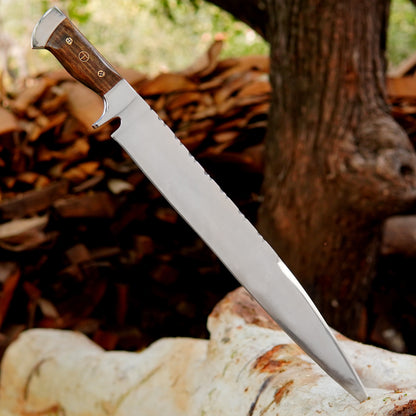 Close view of the fixed blade hunting knife highlighting the polished carbon steel surface and thick spine built for strength and durability. The wooden handle provides a stable grip and balanced control while working outdoors. Perfect for bushcraft camping and general cutting needs this handmade tool offers reliability performance and classic craftsmanship in every detail