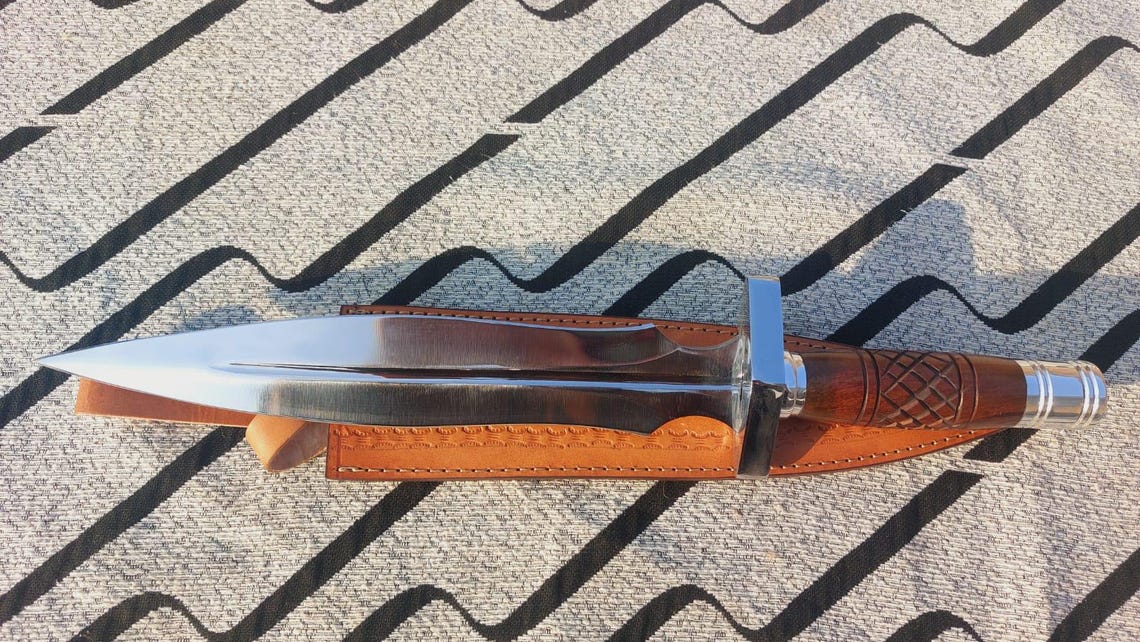 Brown leather sheath for handmade steel dagger knife.