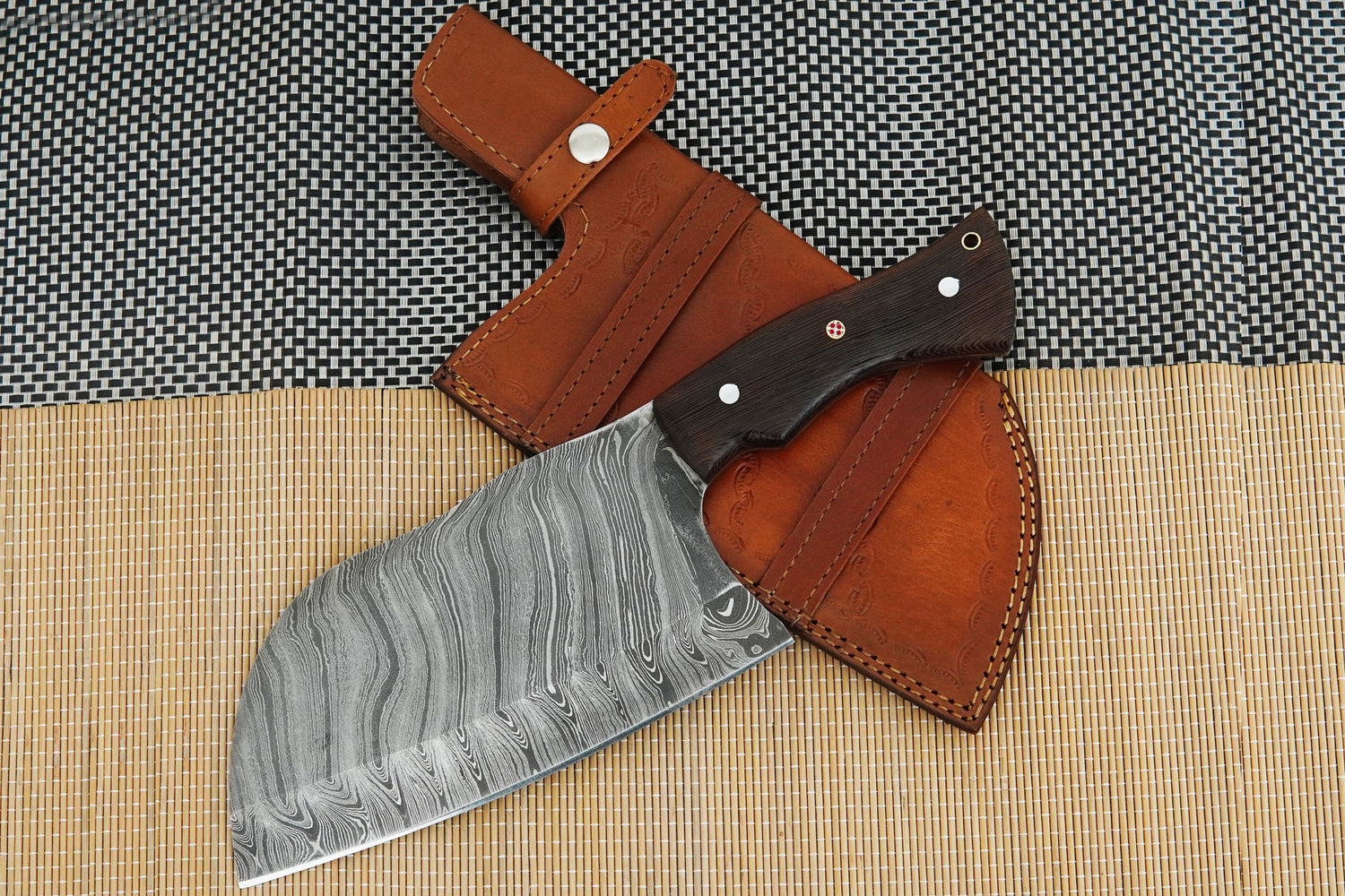 A handmade meat cleaver forged from Damascus steel with a solid full tang design and polished wenge wood handle. Strong and balanced for chopping in the kitchen or BBQ, this knife also makes a thoughtful gift. Free engraving option included.