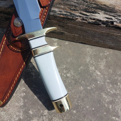 Polished hunting knife with white handle grip and leather sheath. The mirror finish blade ensures sharpness and durability, while the sheath offers safe carrying during outdoor use.