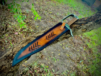 Handmade carbon steel Bowie knife with leather sheath lying on outdoor bench.