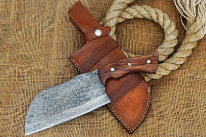 A handmade Serbian chef cleaver forged from Damascus steel with a sturdy full tang design and polished rose wood handle. Perfect for heavy kitchen use, BBQ prep, or outdoor cooking. Free engraving option available to personalise it as a gift.