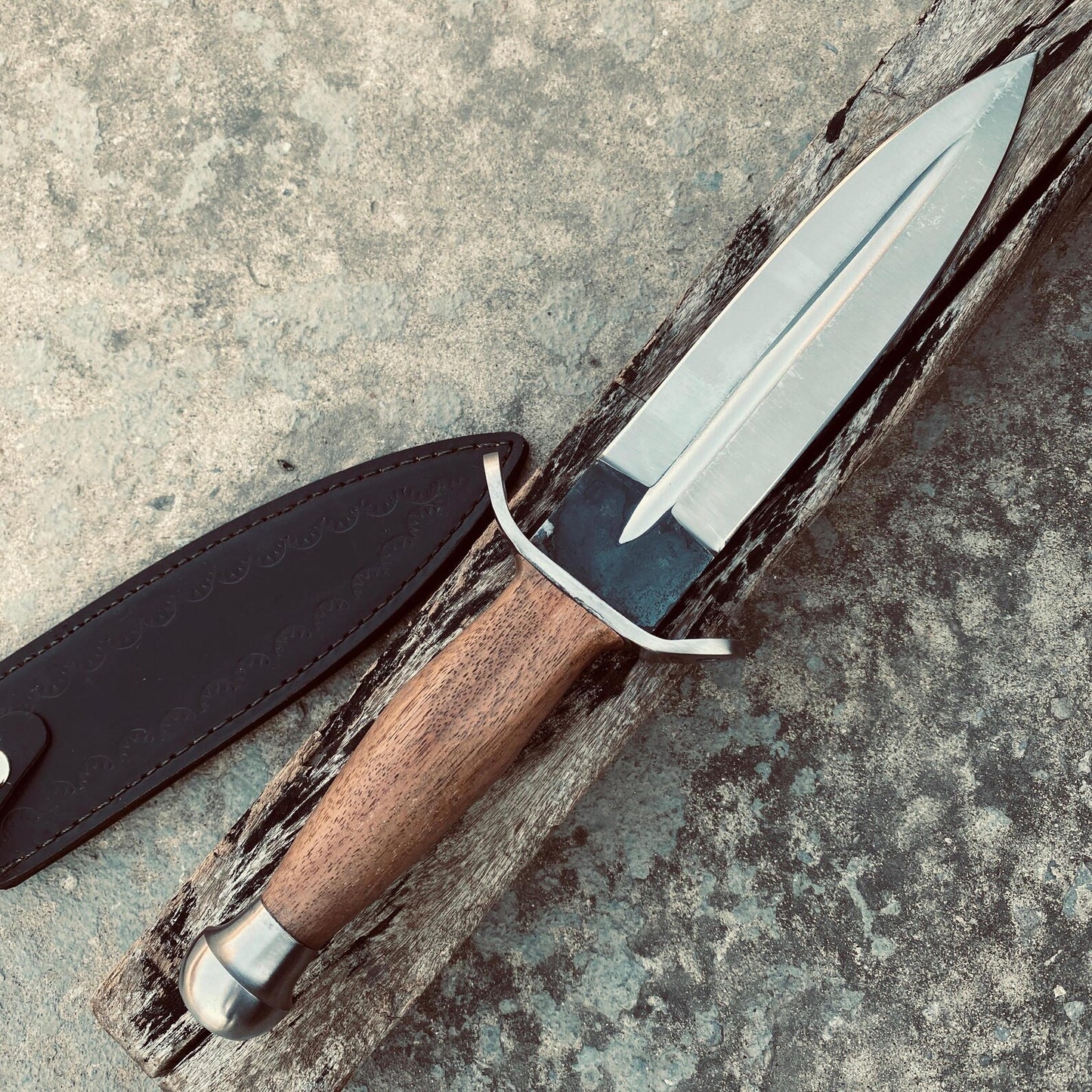 Hand-forged wooden handle dagger knife crafted by skilled artisans.