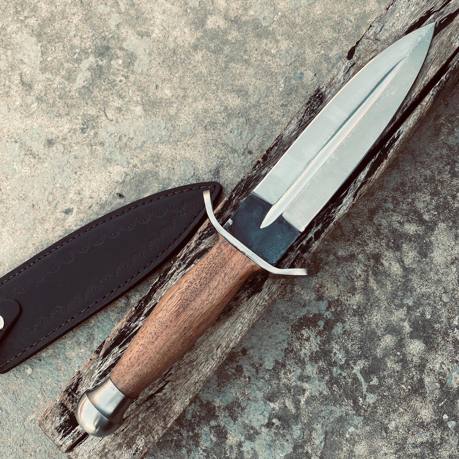 Hand-forged wooden handle dagger knife crafted by skilled artisans.