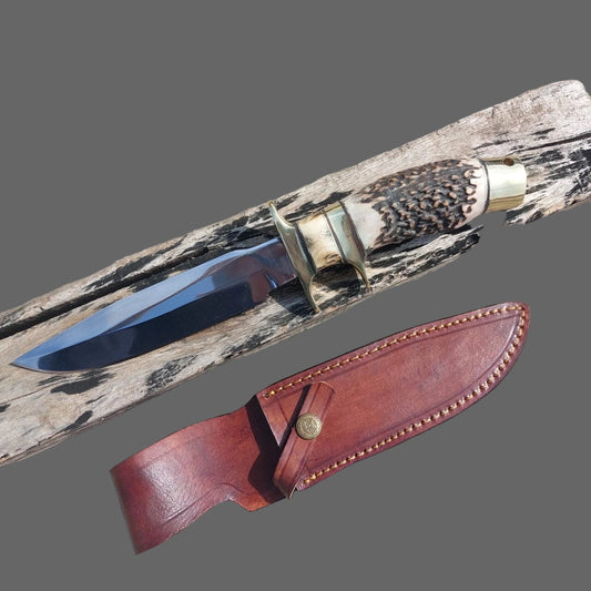 Handmade high carbon steel hunting knife with subhilt guard, polished blade, and brass fittings. Comes with a stitched leather sheath for durability and easy carry. Perfect for outdoor enthusiasts, hunters, and collectors looking for a strong, sharp, and practical knife that combines function with classic craftsmanship.