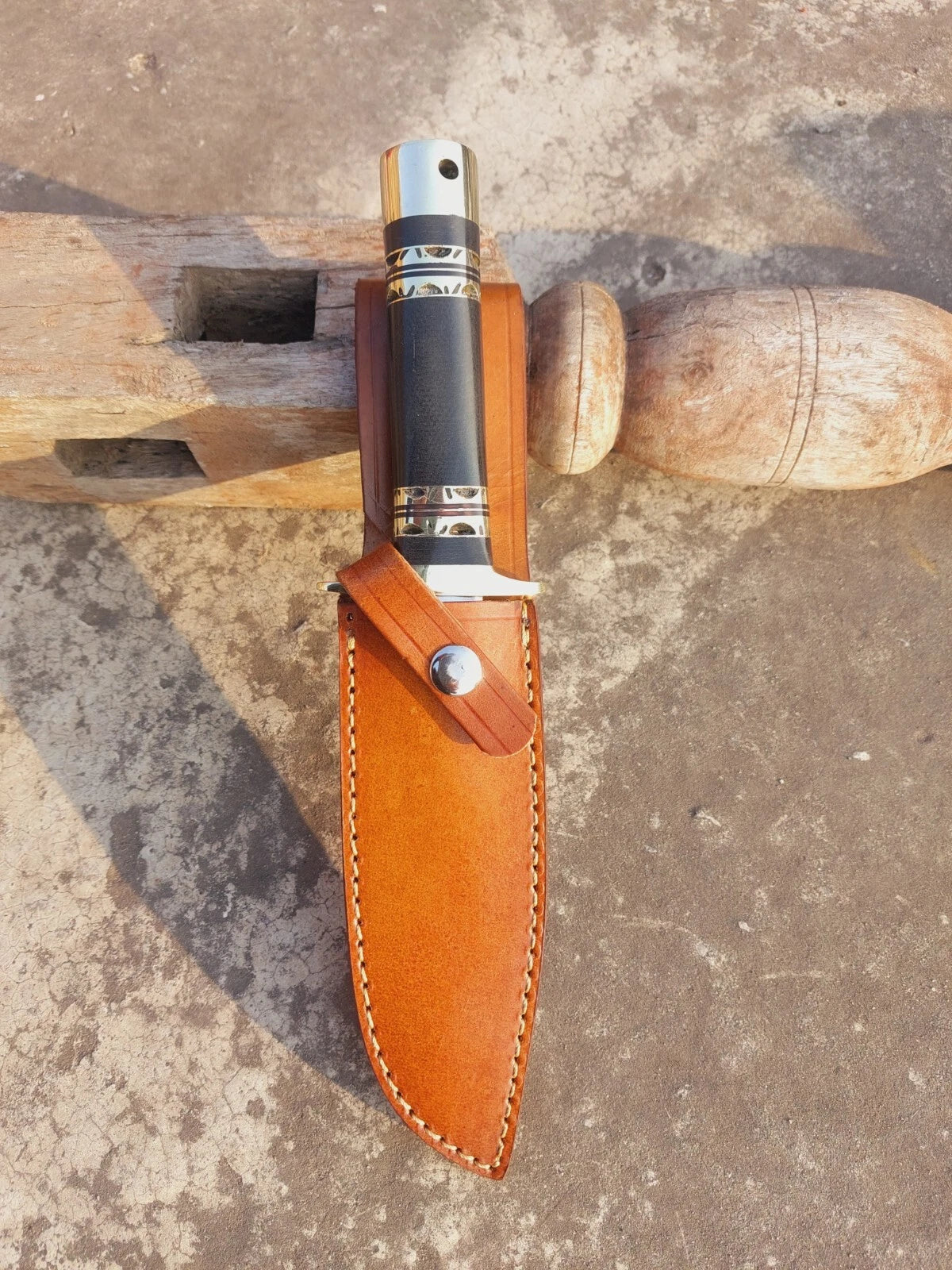 Fixed blade hunting knife featuring a sleek micarta handle with brass guard and butt cap. The mirror-polished blade adds elegance and cutting efficiency. A handmade piece that blends practicality with style, suitable for hunting and camping.