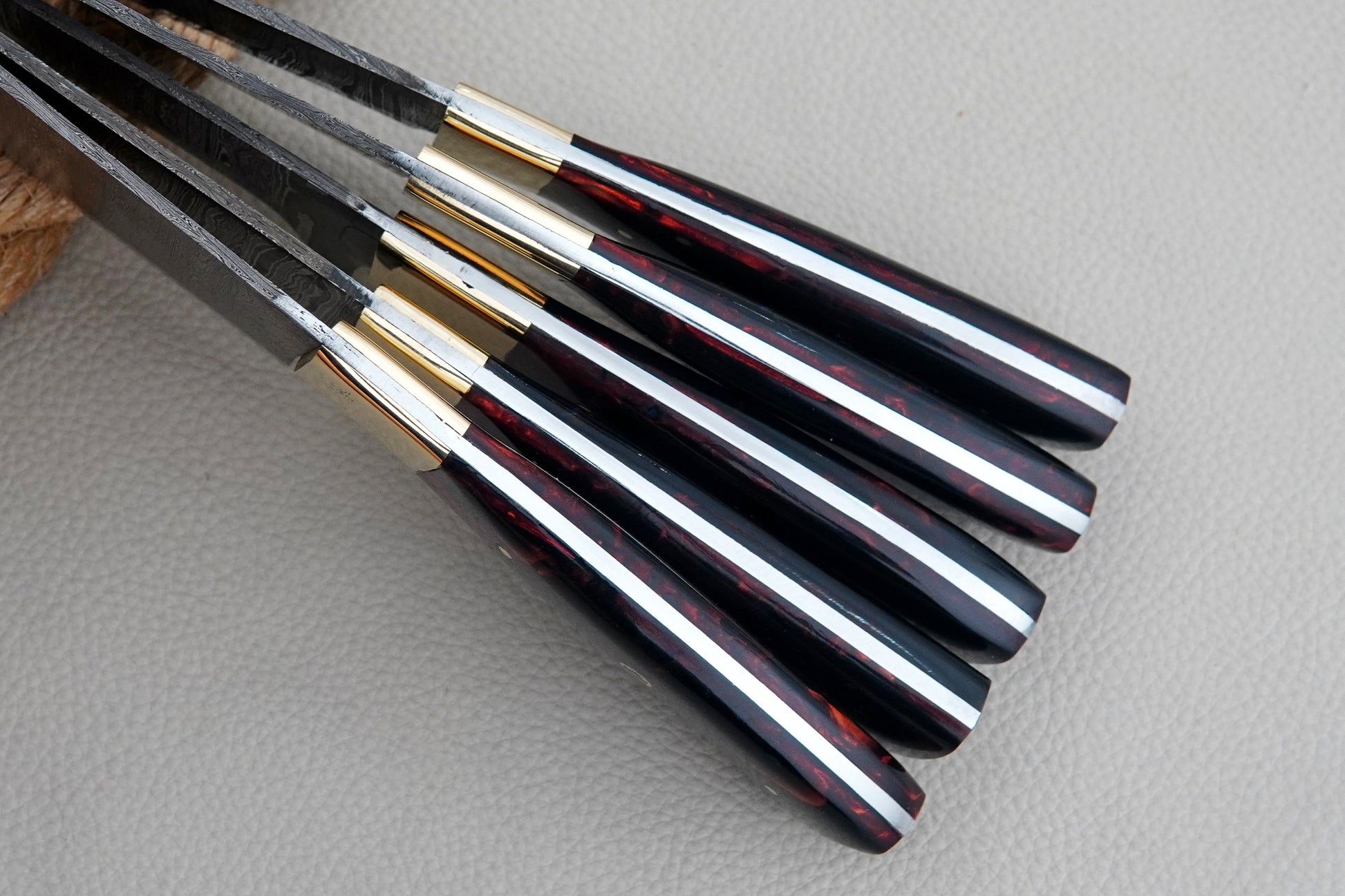 A collectible kitchen knife set made from Damascus steel with resin handles and full tang durability. Handmade with precision, this chef set is suitable for kitchens, BBQs, and outdoor cooking.