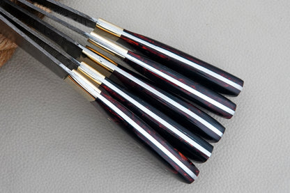 A collectible kitchen knife set made from Damascus steel with resin handles and full tang durability. Handmade with precision, this chef set is suitable for kitchens, BBQs, and outdoor cooking.