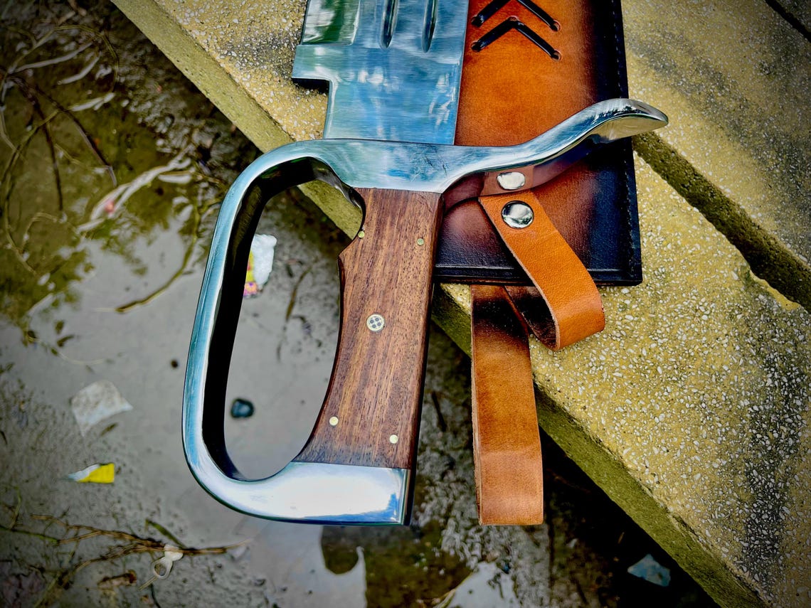 Oversized handmade D-Guard Bowie knife with full tang blade and leather sheath.