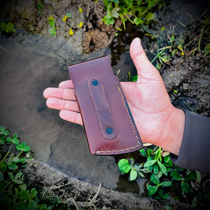 Leather pouch for folding pocket knife displayed separately showing stitched edges and storage design.